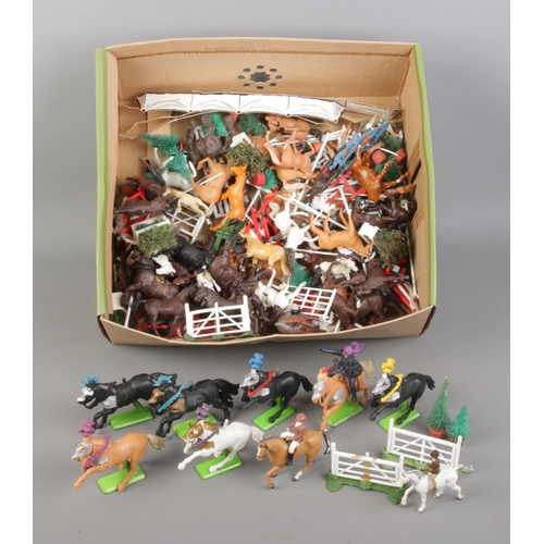 67 - A collection of plastic cavalry and horse figures, including a selection of mixed metal Britain's De... 