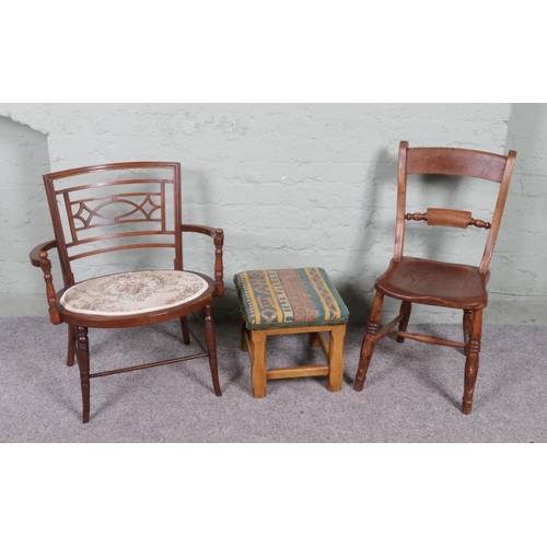 537 - A collection of two vintage chairs and a footstool, featuring a tub chair and a kitchen chair with W... 