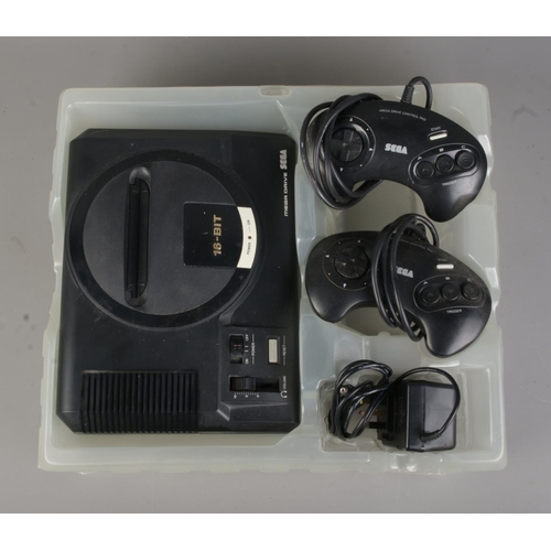 2 - A Sega Mega Drive gaming console, complete with power lead and two controllers, with Sonic the Hedge... 