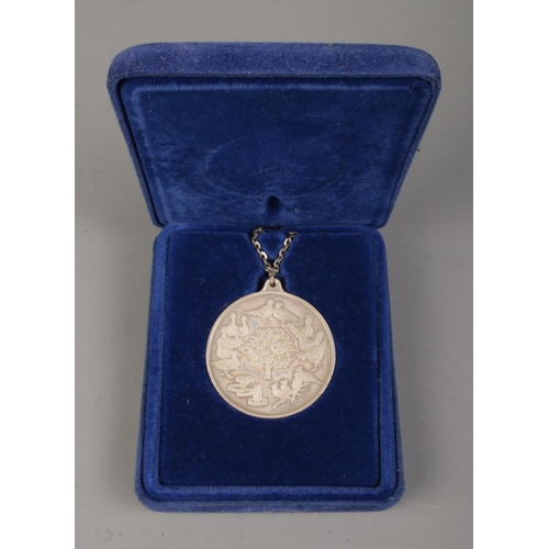 431 - A silver 'Twelve Days of Christmas' Pendant, in case, on silver chain. Total weight: 58.7g