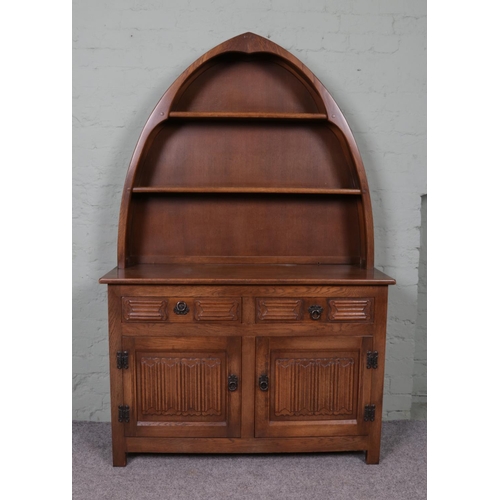 505 - An Old Charm Dutch dresser, with boat-shaped plate rack above cupboard base featuring linen fold dec... 