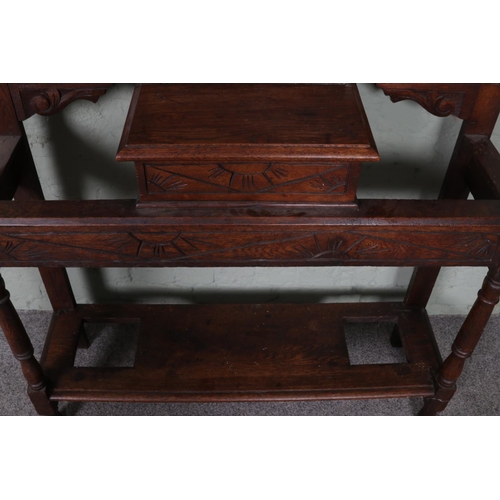 511 - An extensively carved oak hall stand. Featuring central bevel edged mirror and storage box situated ... 