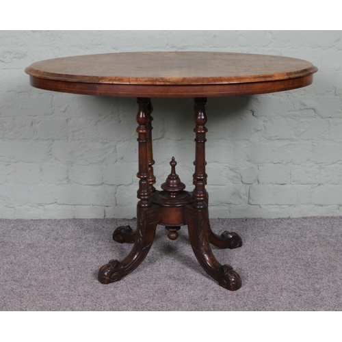 517 - A Victorian inlaid walnut oval side table, with decorative central bobbin pillar, raised on carved c... 