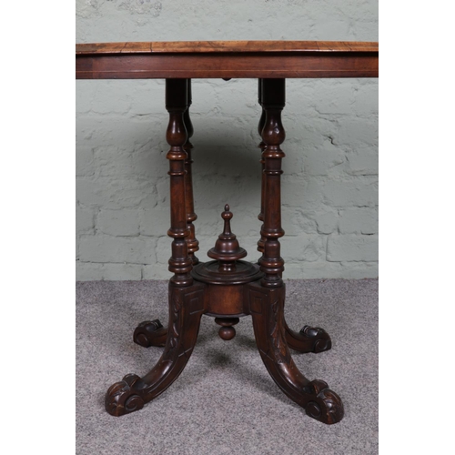 517 - A Victorian inlaid walnut oval side table, with decorative central bobbin pillar, raised on carved c... 