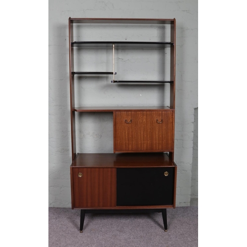 520 - A retro G-Plan E.Gomme room divider unit; containing ebonised shelving, drop down cupboard door and ... 