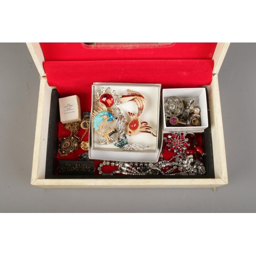 89 - A cream Design Philipp jewellery box containing a collection of costume jewellery. To inckude vintag... 