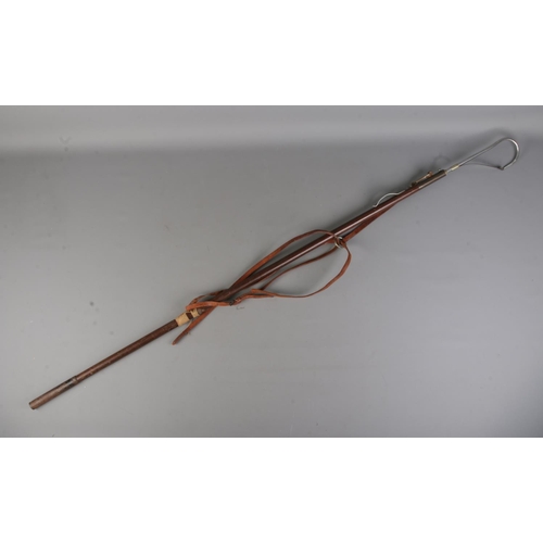 487 - Hardy Bros Ltd, a combined gaff and wading stick, having a steel hook with hook protector leading to... 