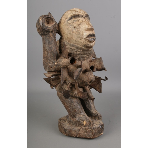 489 - A Wooden 'Nkisi Nkondi' Figure having face painted with white slip and inserted glass eyes, the body... 