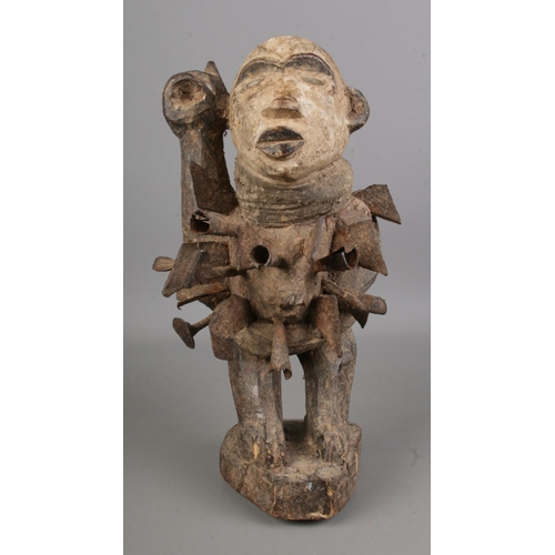 489 - A Wooden 'Nkisi Nkondi' Figure having face painted with white slip and inserted glass eyes, the body... 