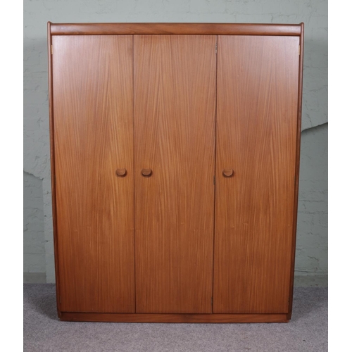 525 - A three door White & Newton Selbourne wardrobe with three shelves and a rail to the interior. 173cm ... 