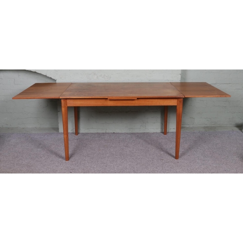 526 - A Danish teak extending dining table with four G Plan Fresco Chairs