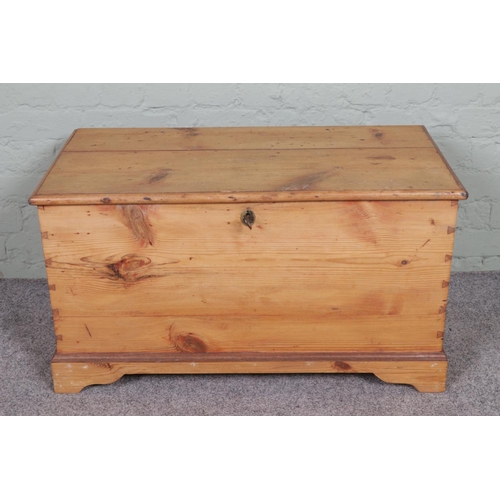 552 - An antique pine blanket box with internal candle box with drawers.