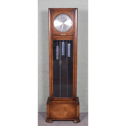 553 - An Art Deco style oak long cased clock with Arabic numeral markers and presentation plaque 'Presente... 