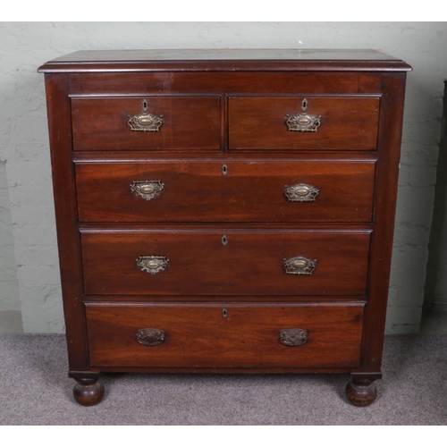 565 - A mahogany chest of two over three drawers, with brass escutcheons and drop down handles. Raised on ... 