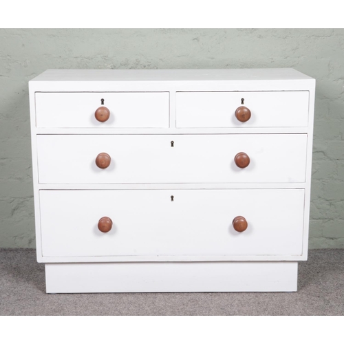 566 - A white painted pine chest of two over two drawers. Height: 81cm, Width: 99cm, Depth: 46cm.