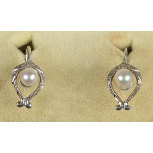 100 - A pair of Mikimoto silver and cultured pearl earrings. With screw backs.