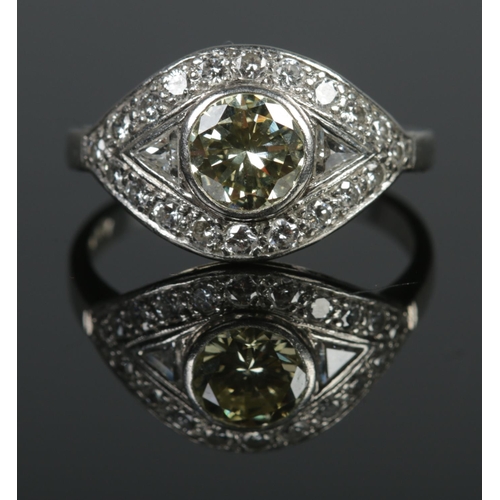 104 - A platinum and diamond ring in eliptical setting, having large central yellow diamond. Central diamo... 