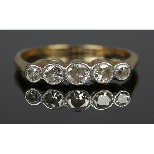 105 - An 18ct yellow gold, platinum and five stone diamond ring. Size K. 1.86g.