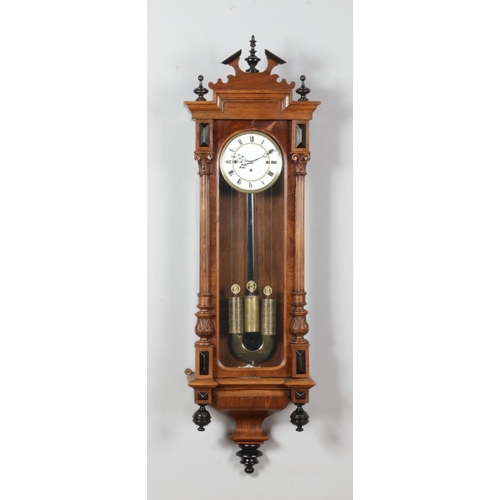 127 - A 19th century walnut cased triple weight Vienna wall clock. Length 132cm.