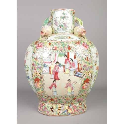 13 - A large Chinese famille rose vase. Decorated with panels depicting figures and birds and having foli... 