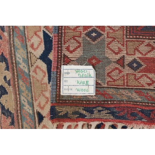 130 - A Turkish Yagcibedir wool rug with geometric design. 110cm x 107cm.