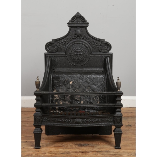 132 - A Victorian cast iron fire grate with sun motif. Bearing date lozenge to back. Width of back plate 4... 