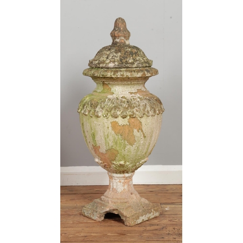 133 - A pair of weathered terracotta lidded garden urns of classical style. C1900. Height 82cm.