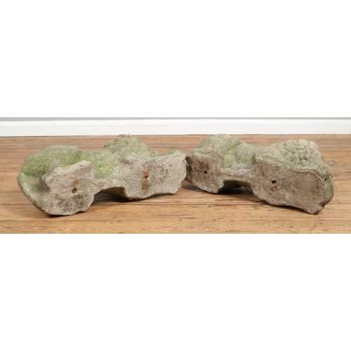 134 - A pair of reconstituted stone crouching lions. Length 59cm.