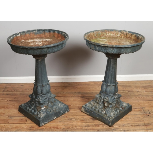 137 - A pair of Victorian style cast iron bird baths. Height 91cm, Diameter of top 61cm.