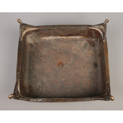 14 - A Japanese bronze desk stand formed as a seated man and a barrel raised on square plinth with scroll... 