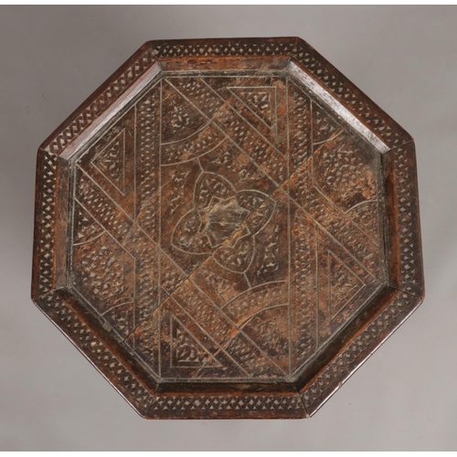 140 - A late 19th/early 20th century carved hardwood octagonal table. Having mother of pearl inlaid star m... 