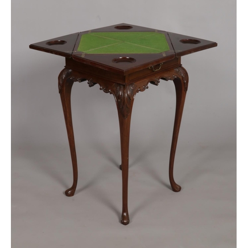 141 - A late Victorian mahogany envelope games table. Raised on cabriole supports.