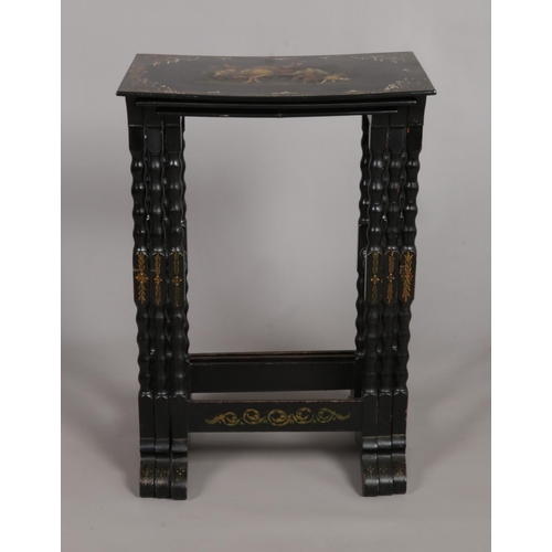 142 - A Victorian nest of three lacquered tables. Each painted with individual scenes, with Highlanders, s... 