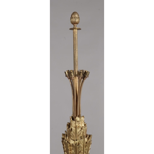 147 - An Ormolu standard lamp with acanthus leaf and feather decoration and acorn finial. Height 198cm.