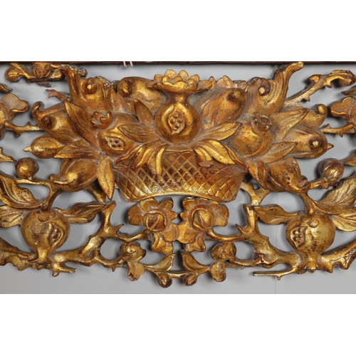 148 - A large late 19th/early 20th century gilt carved wood archway/frieze depicting basket of pomegranate... 