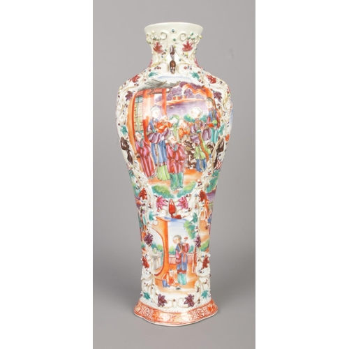 15 - A Chinese famille rose vase of lobed baluster form. Decorated in relief with panels depicting figure... 