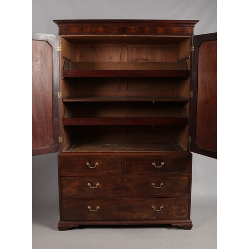 155 - A Georgian mahogany linen press. Having moulded and inlaid doors over drawer base. Height 204cm, Wid... 