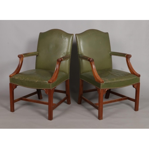 156 - A pair of mahogany Gainsborough elbow chairs. With green leather studded upholstery and carved detai... 