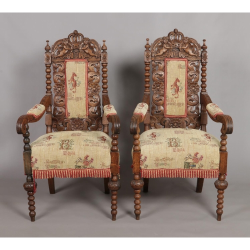 157 - A pair of carved oak throne chairs. Having cherub and crown detailing to the back rests and bobbin t... 