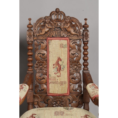 157 - A pair of carved oak throne chairs. Having cherub and crown detailing to the back rests and bobbin t... 