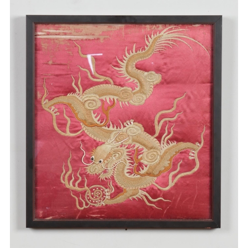 16 - A framed Chinese silk embroided with a dragon. 43cm x 40cm.