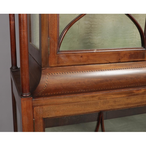 162 - An Edwardian inlaid mahogany two tier display cabinet. Having four turned column supports and taperi... 