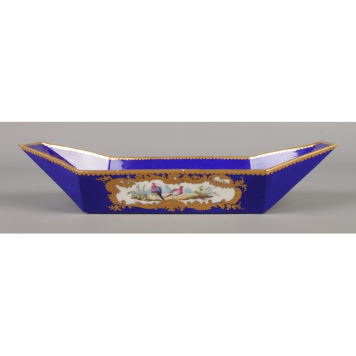 18 - A Sevres style boat shaped stand (bateau). Gros bleu ground with gilt borders and cartouches depicti... 