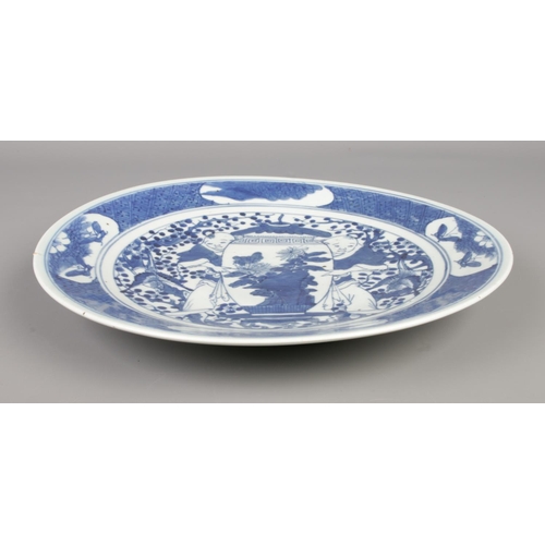 3 - A 19th century Chinese dish decorated in underglaze blue with two figures. Diameter 30cm.