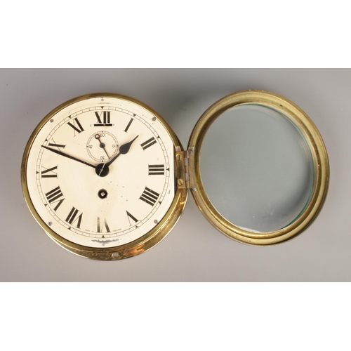 31 - A brass ships clock. Having subsidiary dial and Roman numeral markers. Made in England. Dial diamete... 