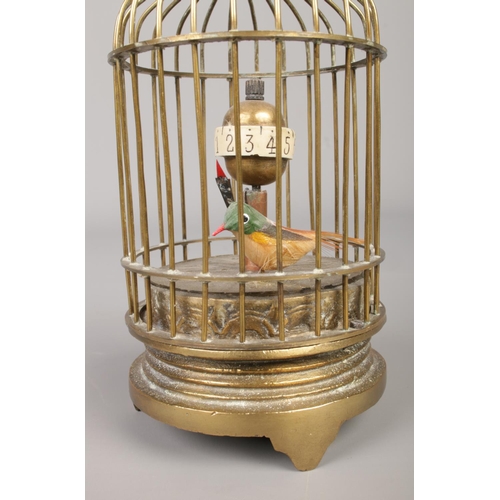 42 - A mechanical brass bird cage clock. Height 12.5cm.