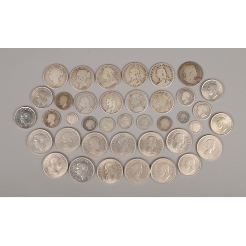 59 - A collection of British pre decimal coinage, including silver examples. George III half crown 1816, ... 