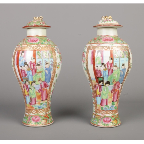 6 - A pair of Chinese famille rose lidded baluster vases. Height 28.5cm.