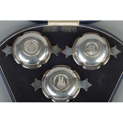 61 - Robert Edgar Stone for Asprey, a cased silver three piece commemorative quaich set. All inset with m... 