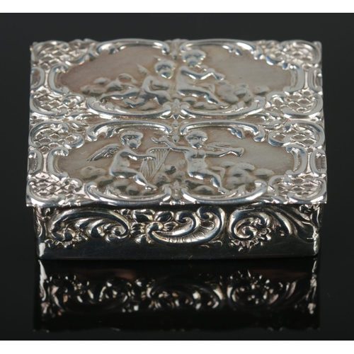 88 - An Elizabeth II silver pill box with embossed cherub decoration. Assayed London 1978 by Da-mar Silve... 